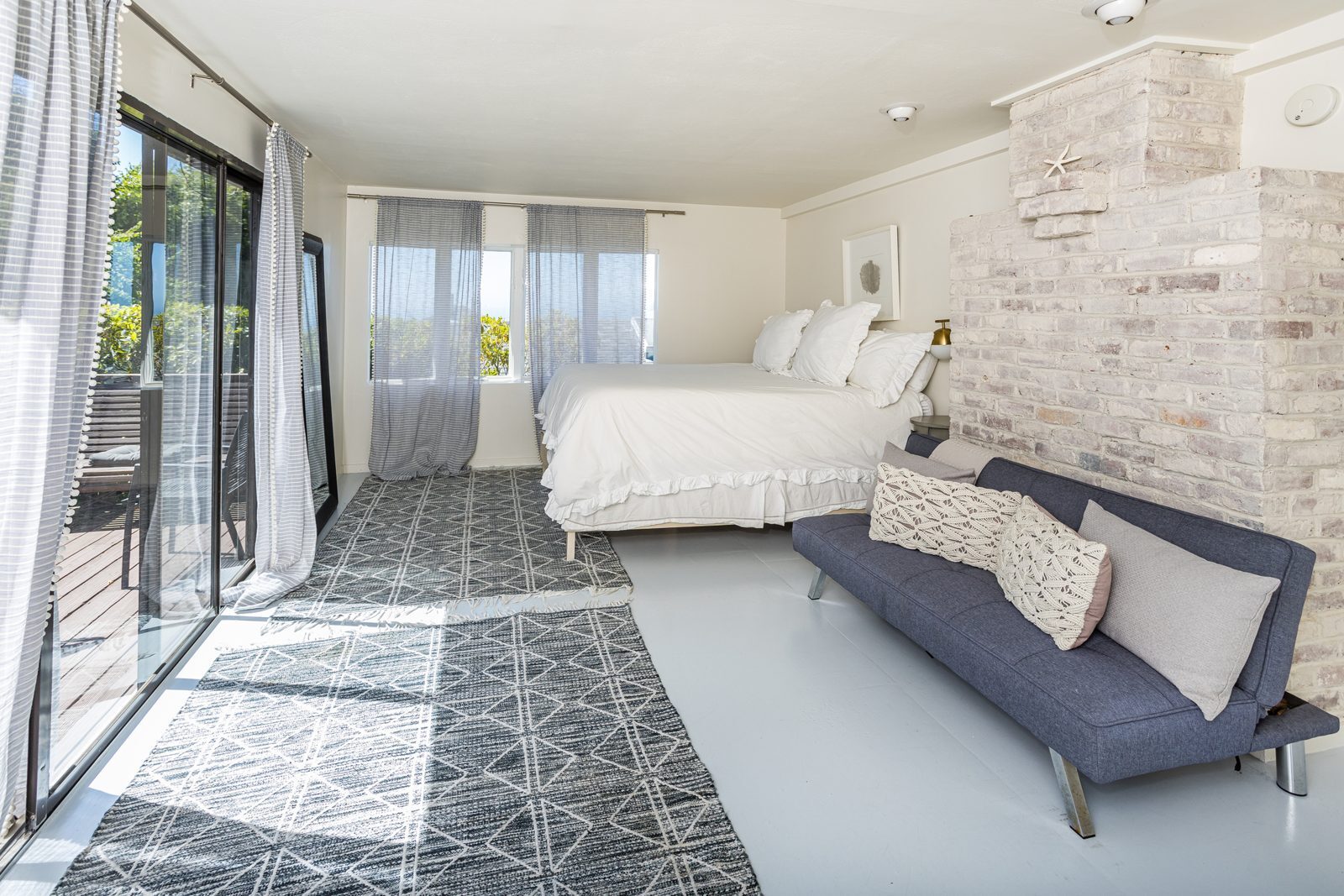 Primary bedroom with brick fireplace wall