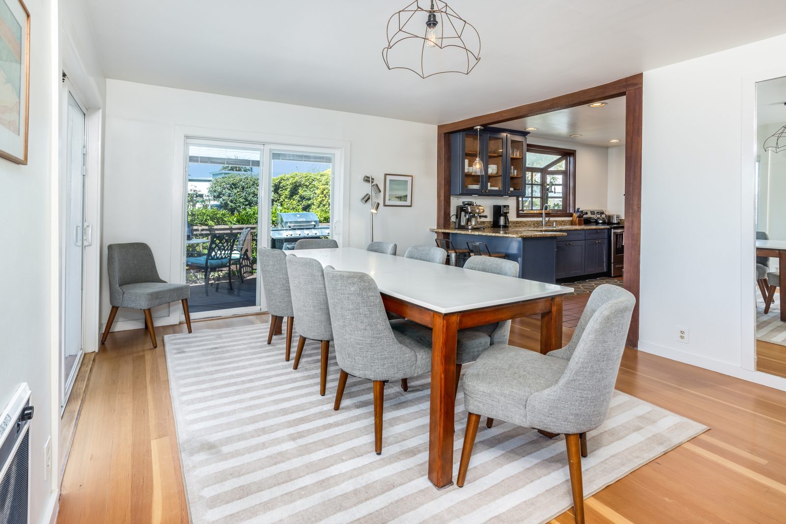 Dining room opening to the kitchen and deck