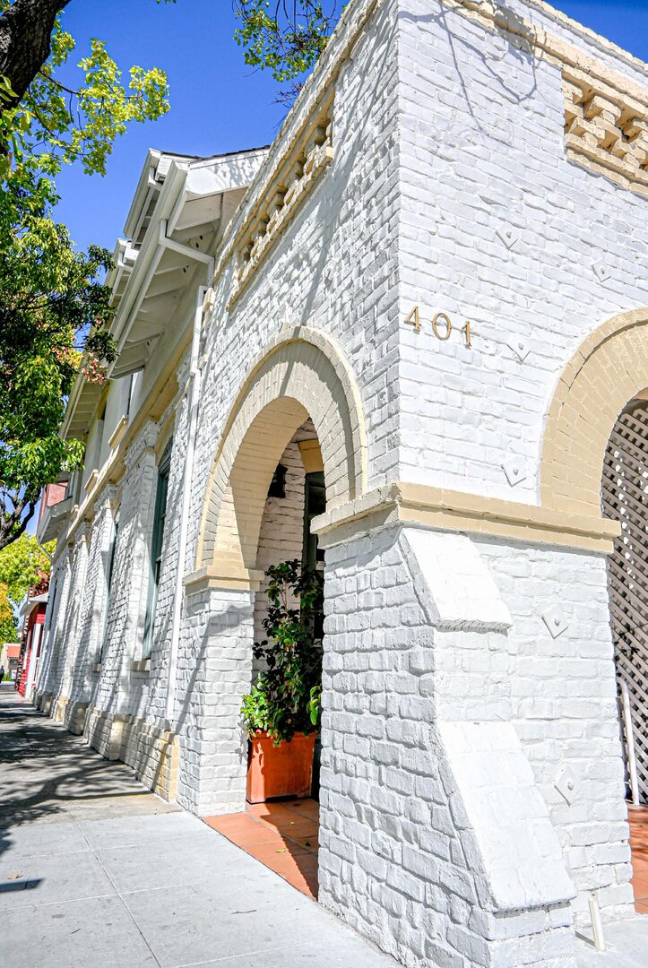 Street view of the building facade and arched entry