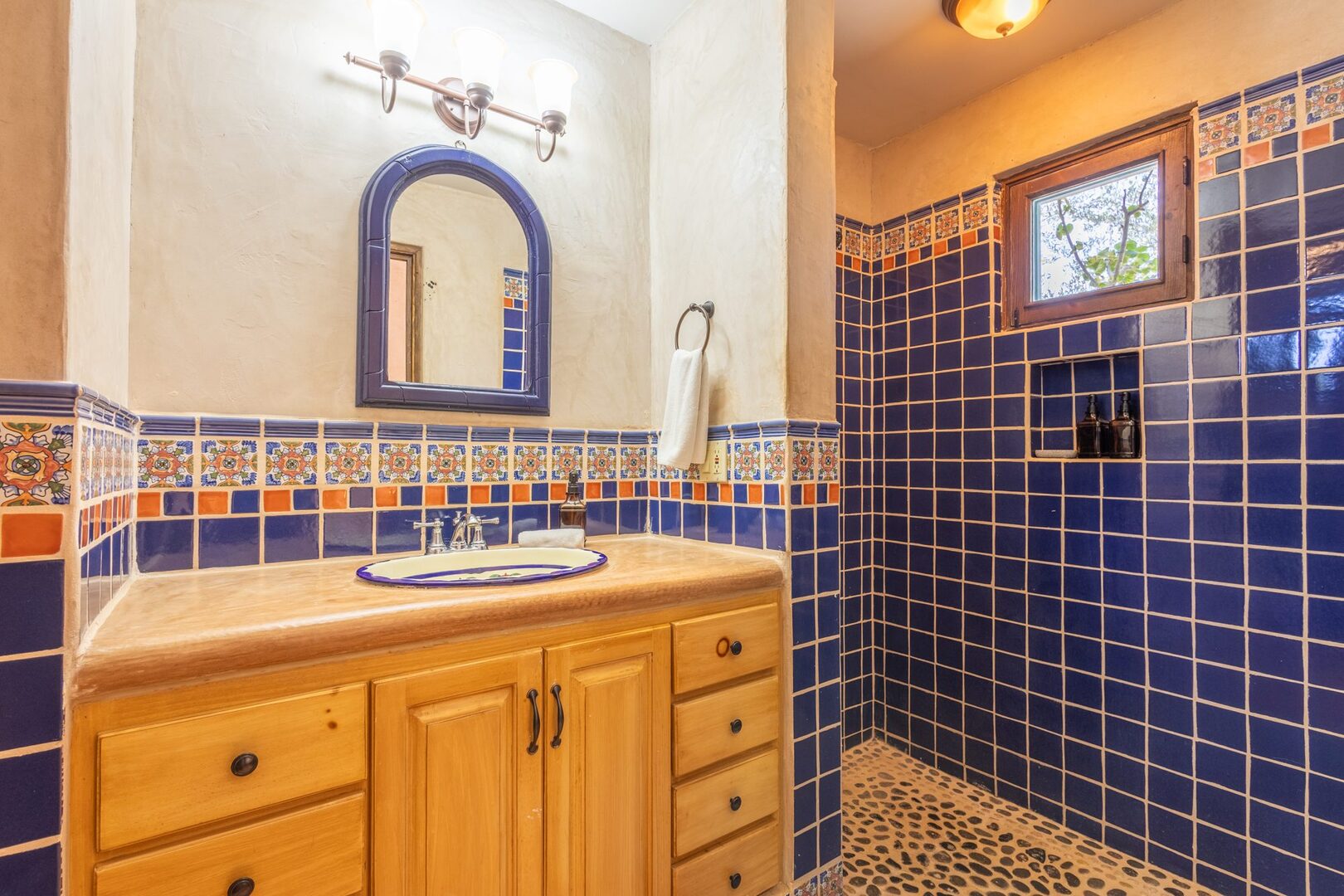 Bathroom with cobalt tiled walk-in shower