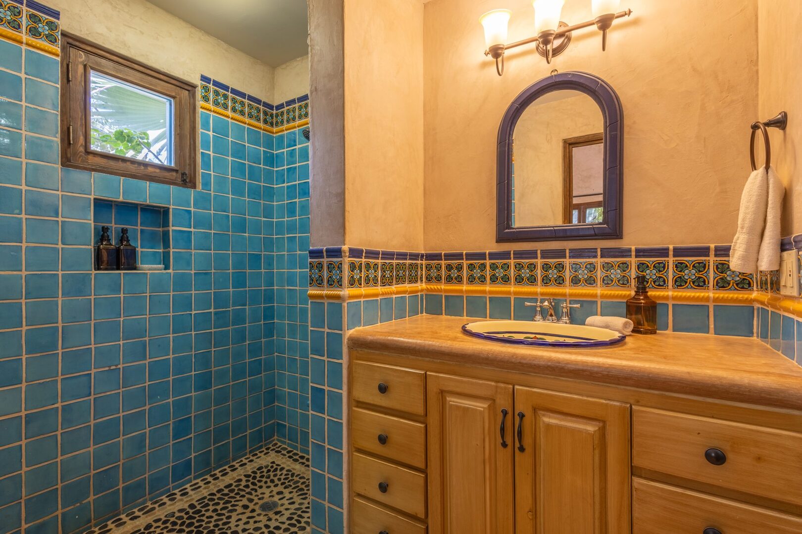 Bathroom with teal Talavera tile and double sinks