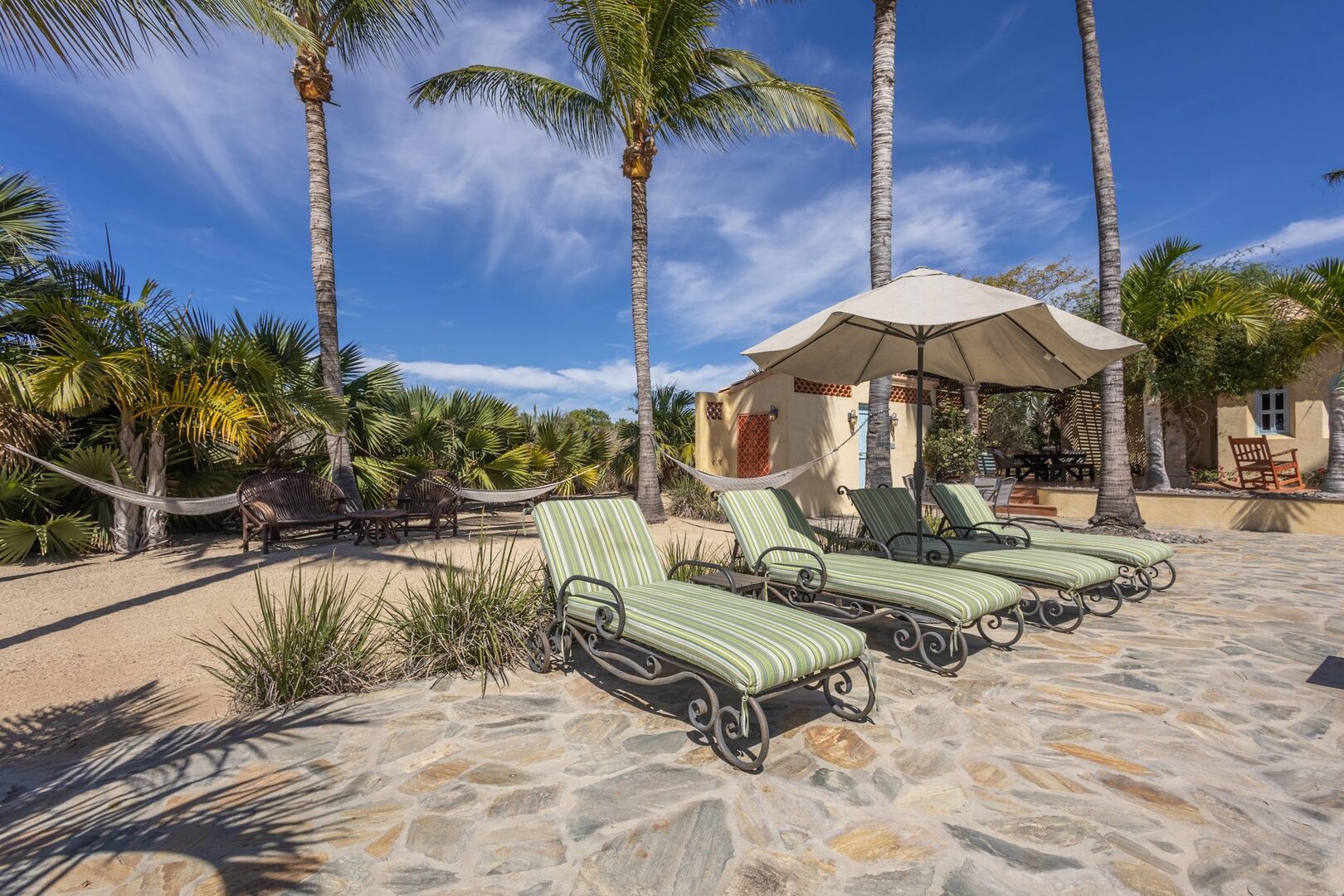 Loungers and hammocks beside the pool with casitas beyond